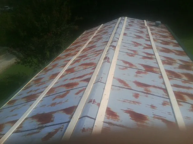Rusted metal roof panels with new wood purlins before replacement — Storm Damage Roof Repair in Hastings On Hudson by Roofing Brothers