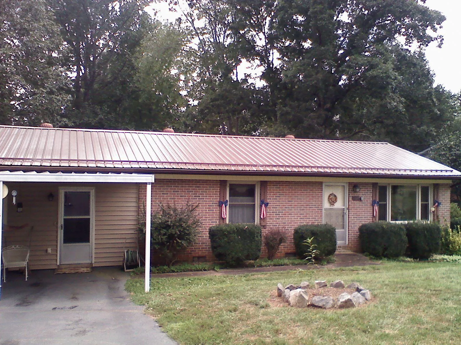 Bronze metal roof and carport on a brick ranch home — Roof Repair work by our crew in Hastings On Hudson